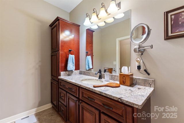 bathroom featuring tile patterned floors, baseboards, and vanity