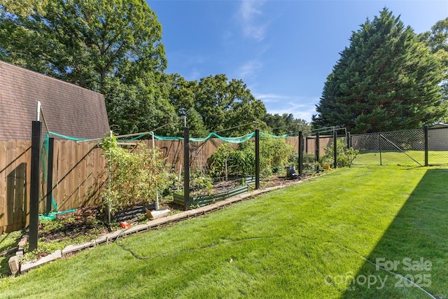 view of yard featuring a vegetable garden and a fenced backyard