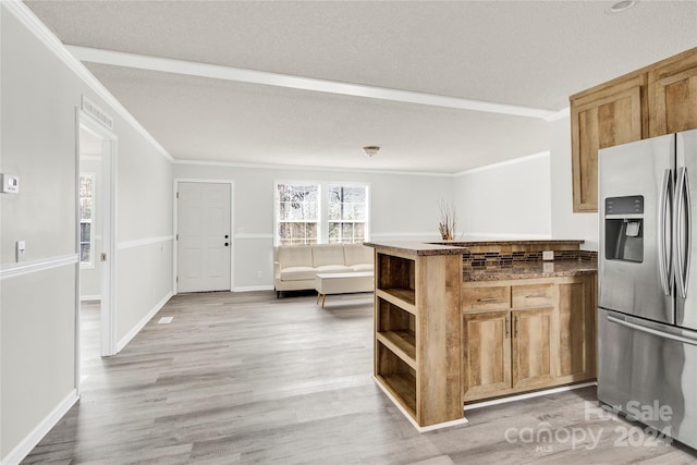 kitchen featuring stainless steel fridge, crown molding, a textured ceiling, and light hardwood / wood-style flooring