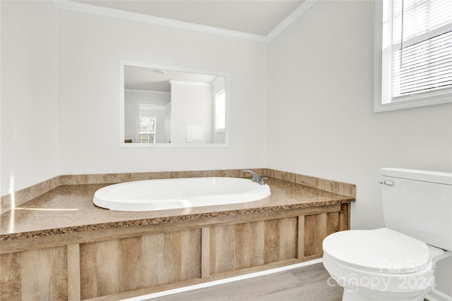 bathroom featuring a washtub, toilet, wood-type flooring, and crown molding