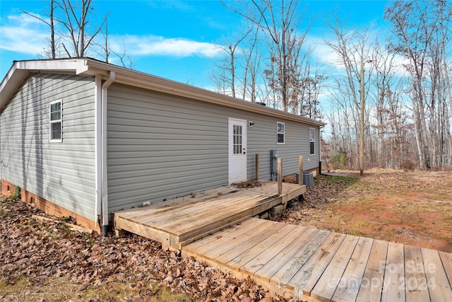 back of property featuring a wooden deck and central AC