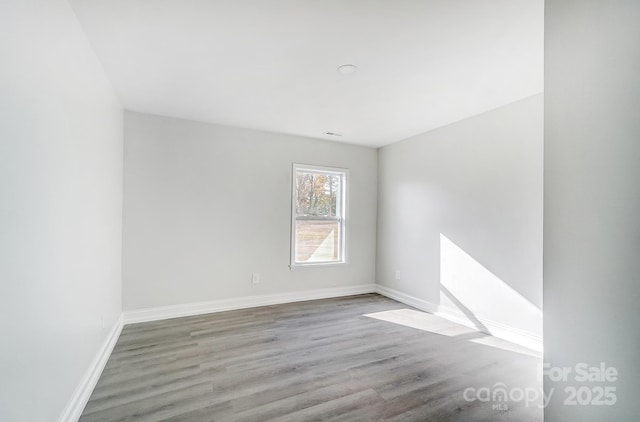 unfurnished room featuring wood-type flooring