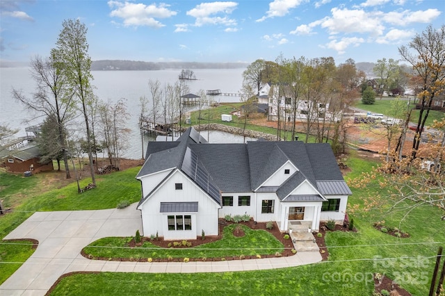 view of front facade with a water view and a front lawn