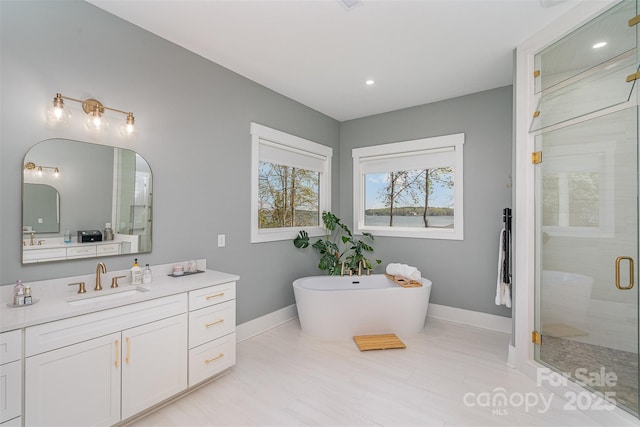 bathroom featuring vanity and shower with separate bathtub