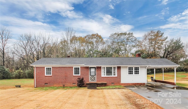 ranch-style home with a carport