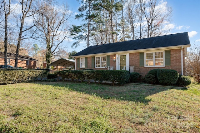 ranch-style home with a front yard and a carport