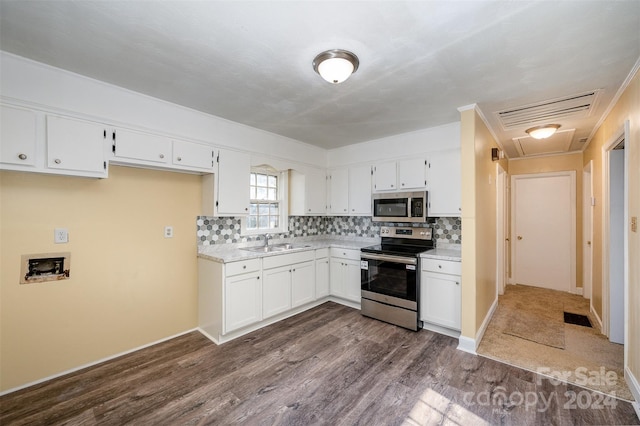 kitchen with white cabinets, appliances with stainless steel finishes, and sink