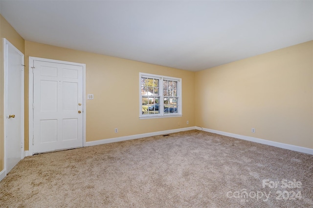 unfurnished room with light carpet