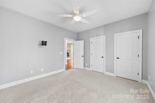 unfurnished bedroom with ceiling fan and carpet