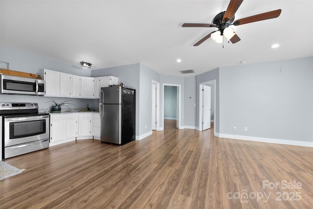 kitchen featuring white cabinets, sink, dark hardwood / wood-style floors, ceiling fan, and appliances with stainless steel finishes