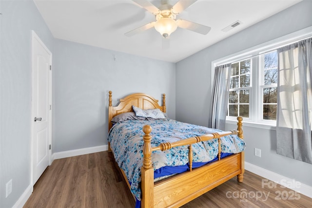 bedroom featuring ceiling fan and dark hardwood / wood-style flooring