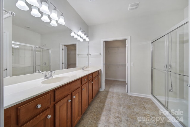 bathroom featuring vanity and an enclosed shower