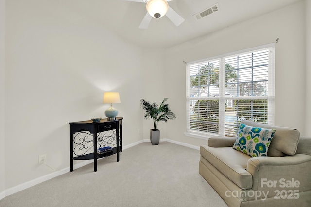 sitting room with visible vents, a ceiling fan, baseboards, and carpet floors