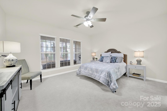 bedroom with light colored carpet, a ceiling fan, and baseboards