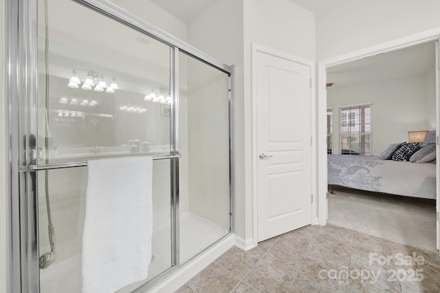 ensuite bathroom featuring a shower stall and connected bathroom