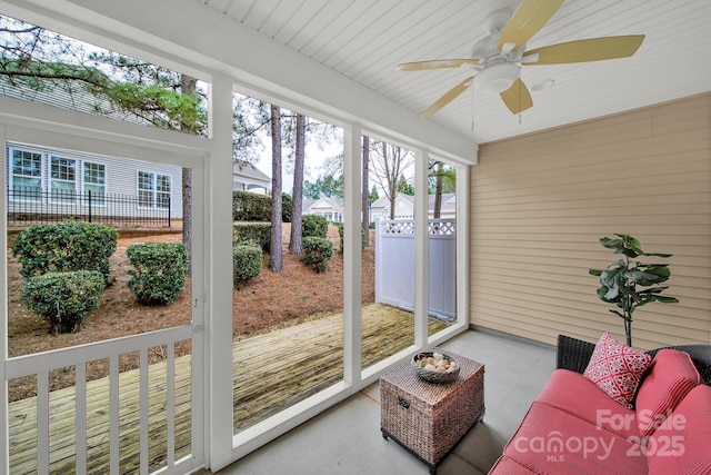 sunroom / solarium with a ceiling fan