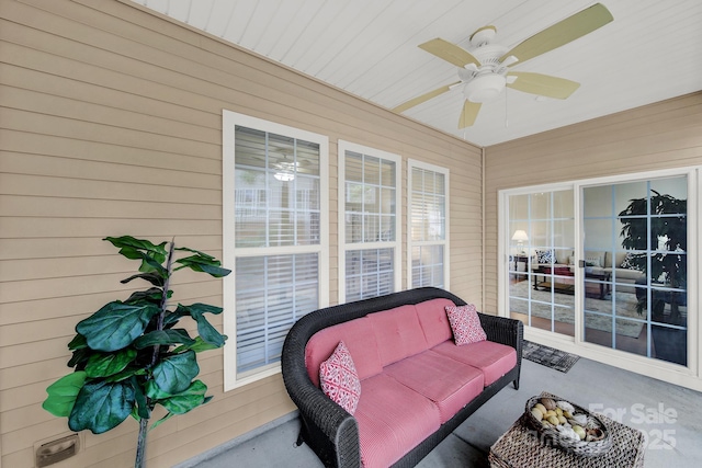 sunroom / solarium with a ceiling fan