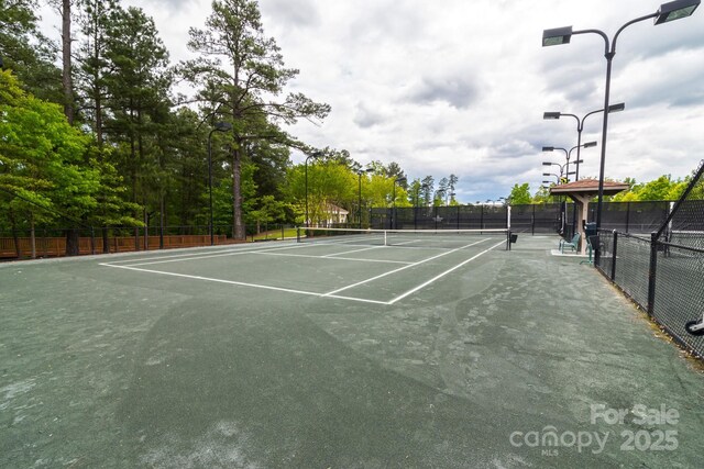 view of sport court featuring fence