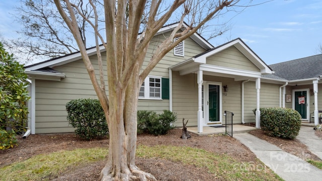 view of front of property featuring roof with shingles