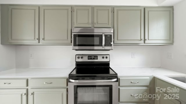 kitchen with appliances with stainless steel finishes and light countertops