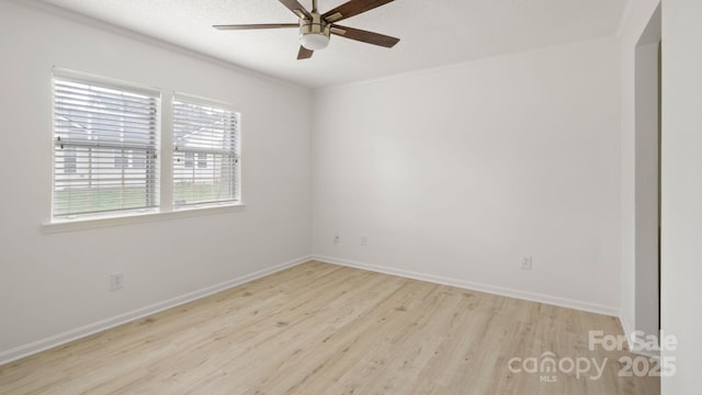 unfurnished room featuring a textured ceiling, light wood finished floors, a ceiling fan, and baseboards