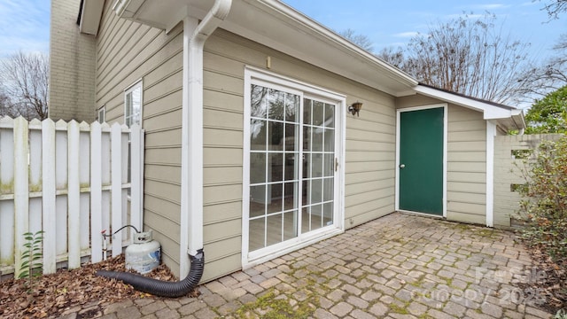 view of outbuilding featuring fence