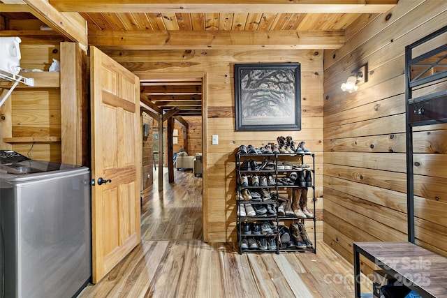 wine area with washer / clothes dryer, wooden walls, and wooden ceiling