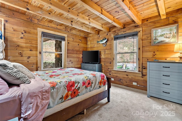 carpeted bedroom featuring beam ceiling, wooden walls, and wooden ceiling