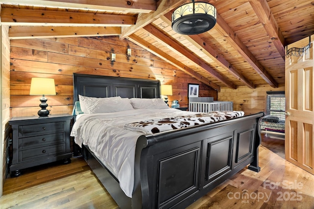 bedroom featuring vaulted ceiling with beams, wood walls, wooden ceiling, and light wood-type flooring