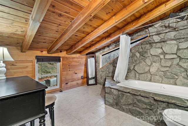 bathroom with beamed ceiling, a bathing tub, and wood walls