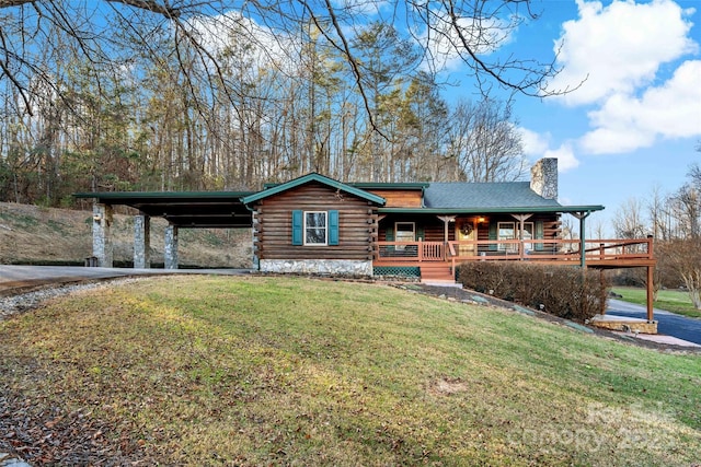 cabin with a front lawn, covered porch, and a carport