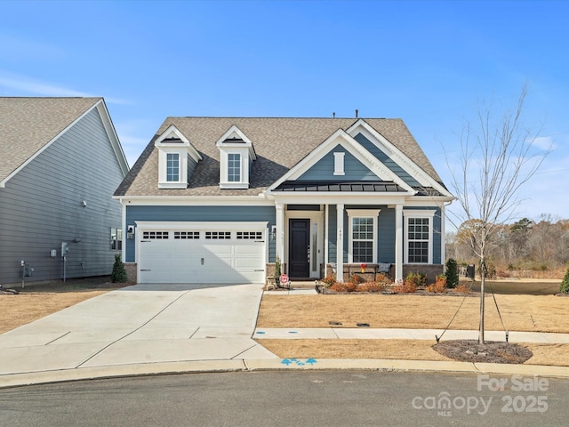 view of front of property with a garage, driveway, a shingled roof, and a porch