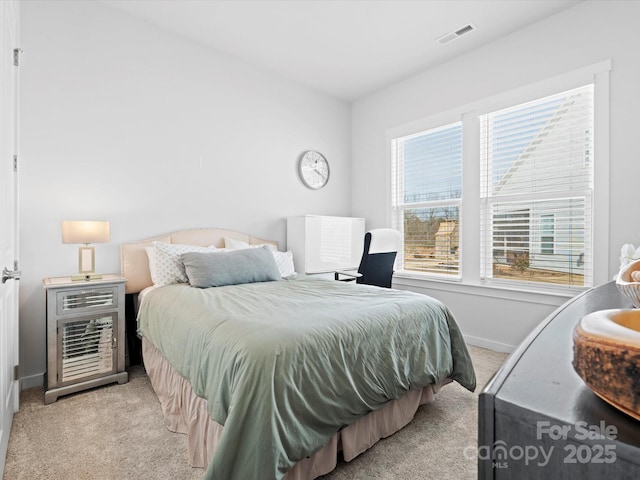 bedroom featuring light colored carpet, visible vents, and baseboards