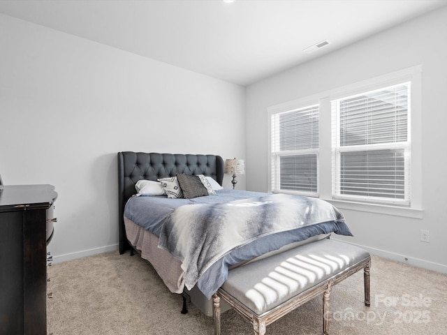 bedroom featuring light carpet, visible vents, and baseboards