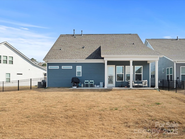 rear view of property with a yard, fence private yard, and a patio