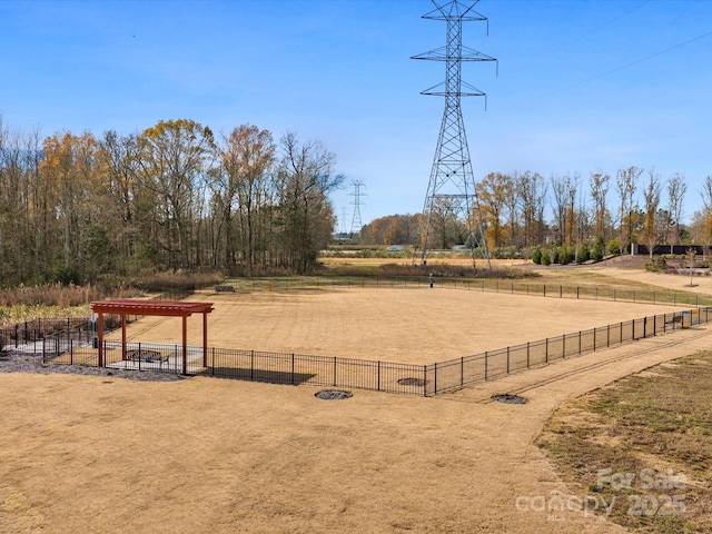 view of home's community featuring fence and a rural view