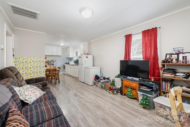 living room with light wood-type flooring and crown molding