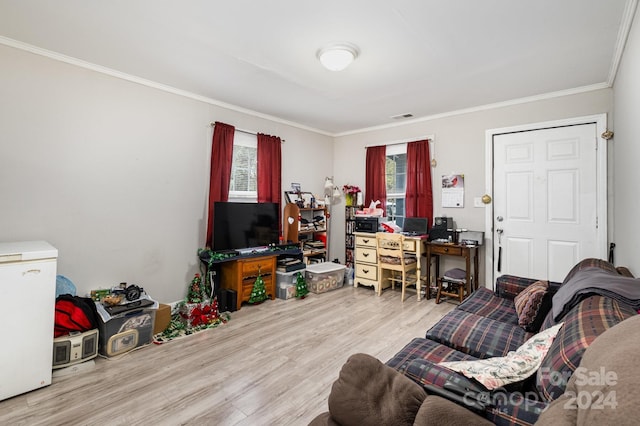 living room featuring light hardwood / wood-style floors and crown molding