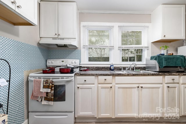 kitchen with white cabinetry, sink, white electric range, dark stone counters, and ornamental molding