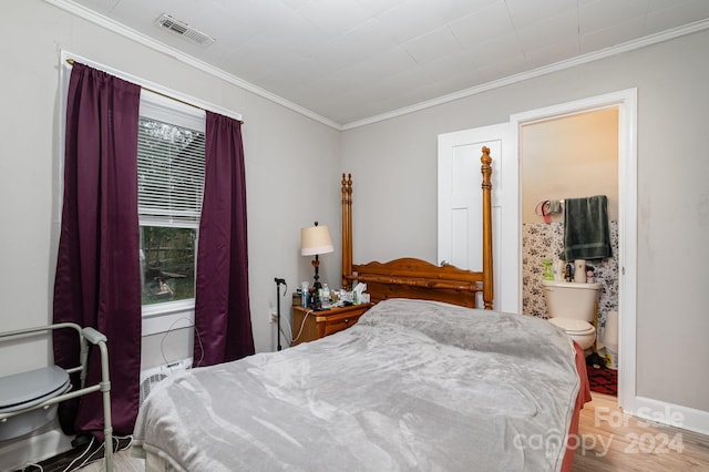 bedroom featuring ornamental molding, light hardwood / wood-style flooring, connected bathroom, and multiple windows