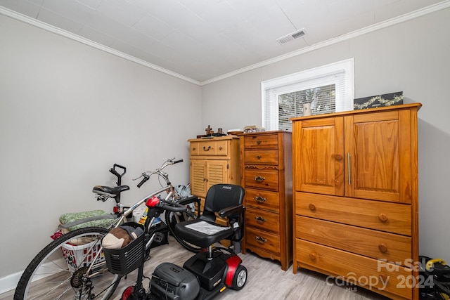 interior space featuring crown molding and light hardwood / wood-style floors