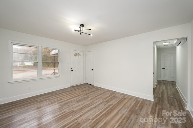 empty room with baseboards and wood finished floors