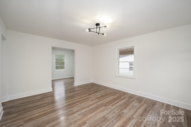 unfurnished room featuring wood finished floors and baseboards