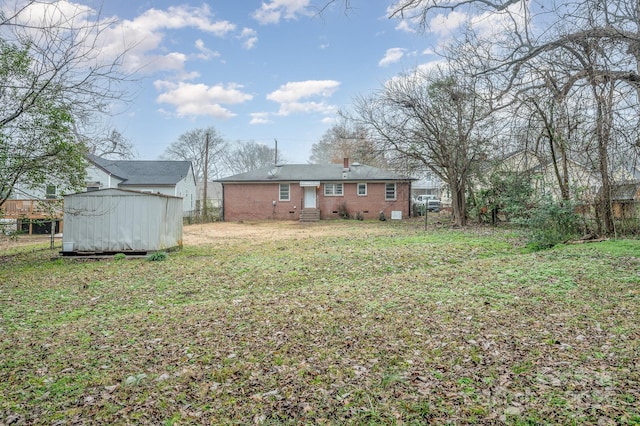 view of yard with an outbuilding, fence, and a storage shed