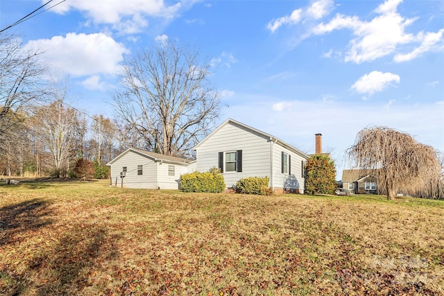 view of property exterior with a lawn