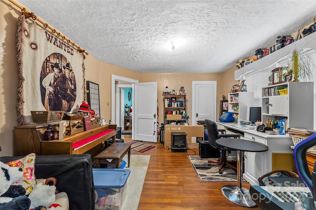 office area with a textured ceiling and hardwood / wood-style flooring