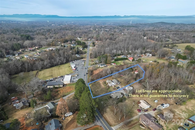 birds eye view of property with a mountain view