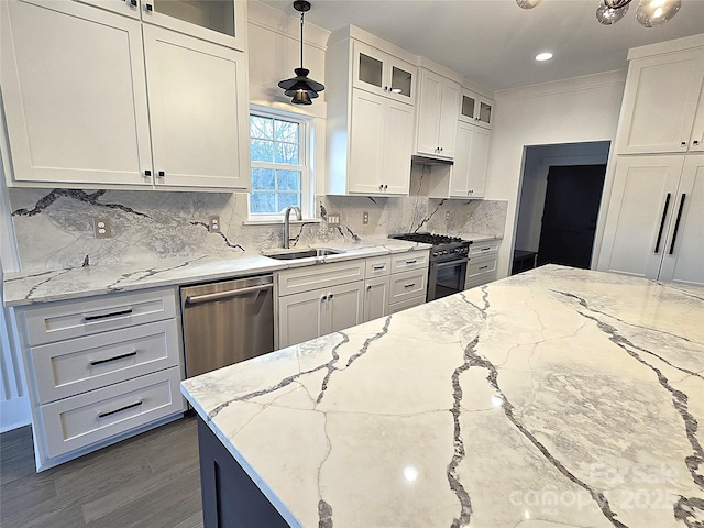 kitchen with stainless steel appliances, sink, pendant lighting, and light stone counters