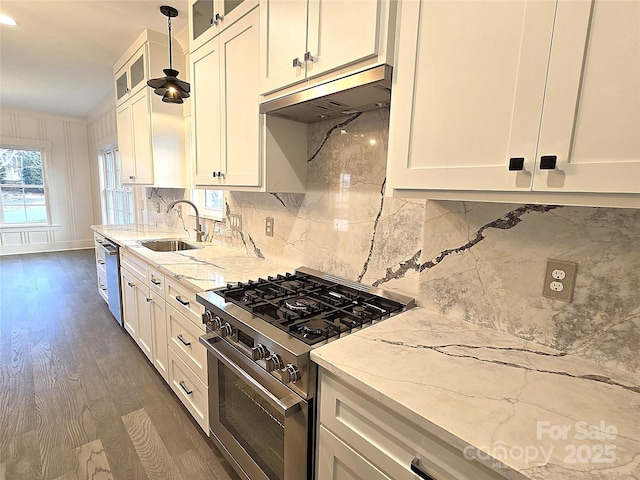 kitchen with sink, white cabinetry, pendant lighting, stainless steel appliances, and light stone countertops