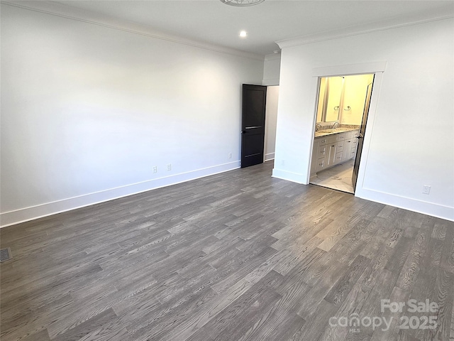 unfurnished room featuring crown molding and dark hardwood / wood-style flooring